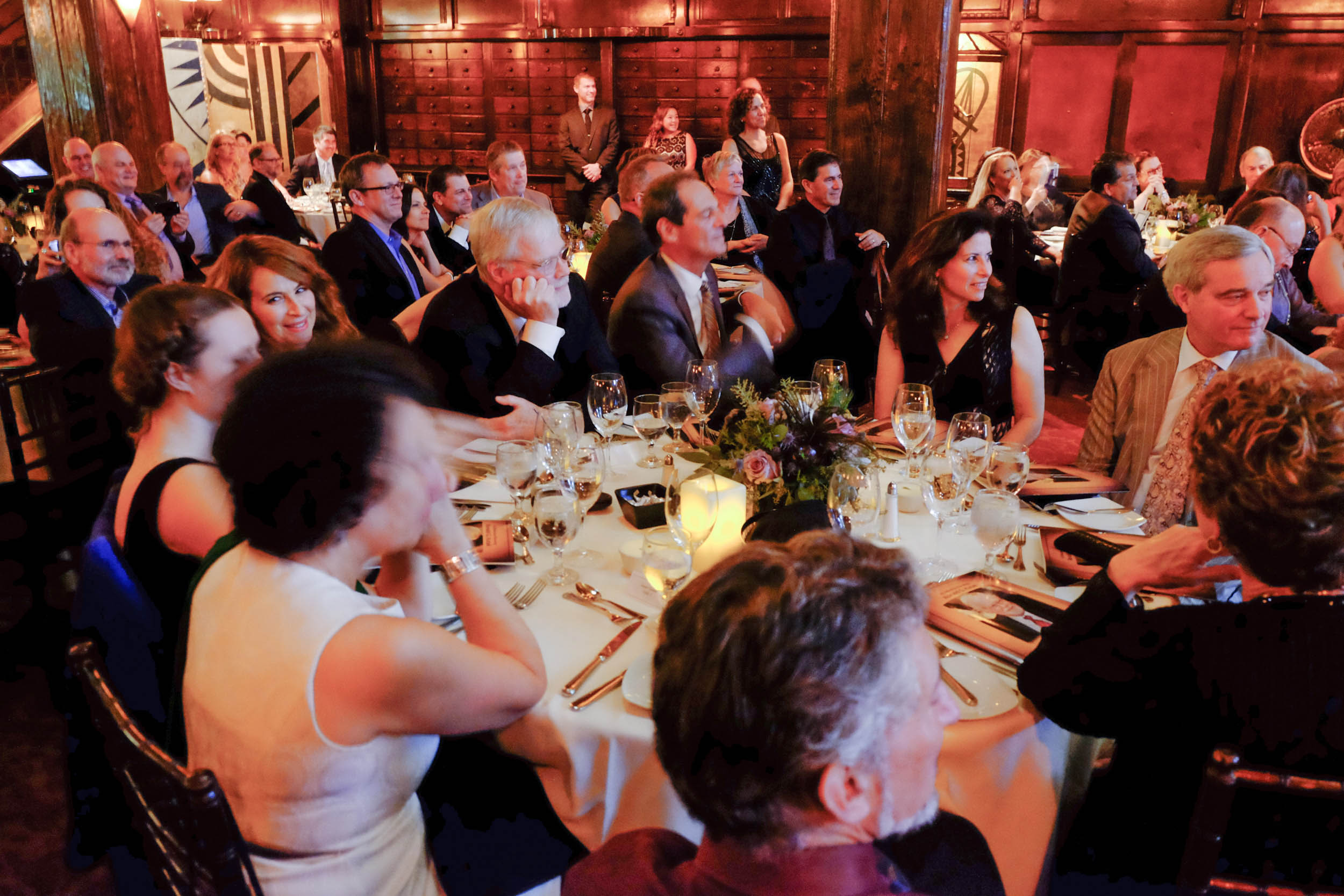 Ron Kutak, center, listening to tributes at his retirement gala. Photo by Wm. Stetz