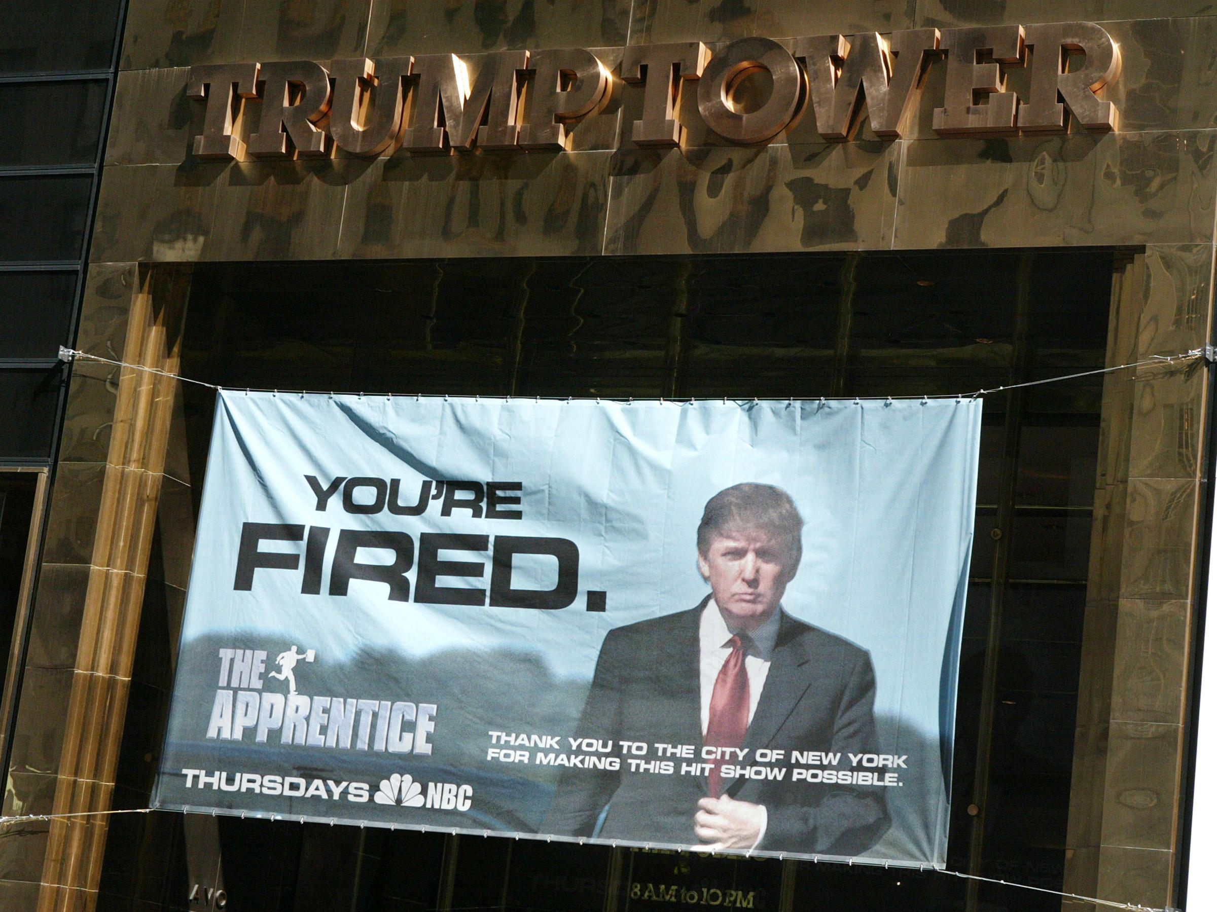 A sign advertising Trump's television show The Apprentice hangs at Trump Towers in New York City in 2004. Courtesy NBC